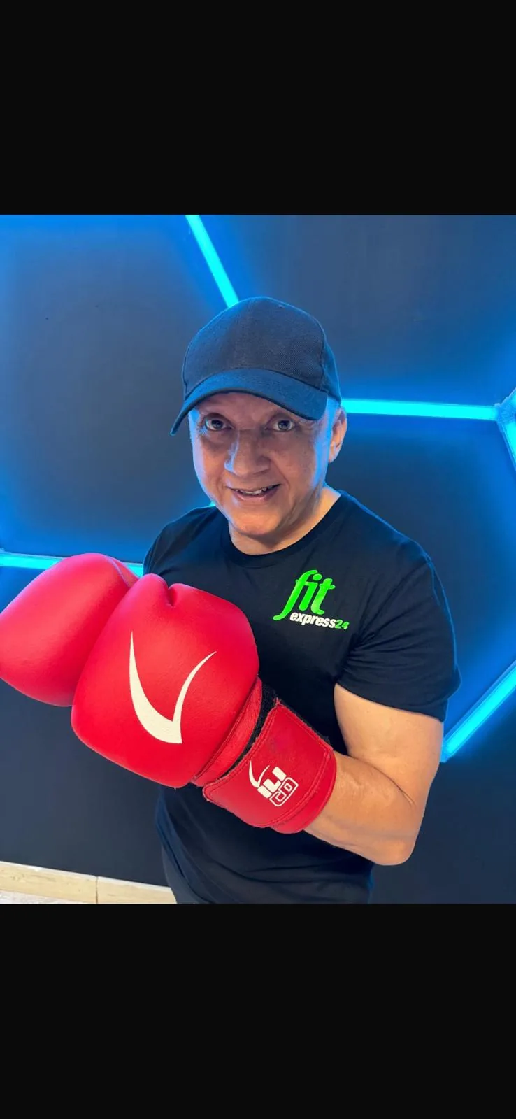 Box Fit coach wearing red boxing gloves